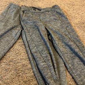 2 pairs of grey Adidas pants. 1 large and 1 medium